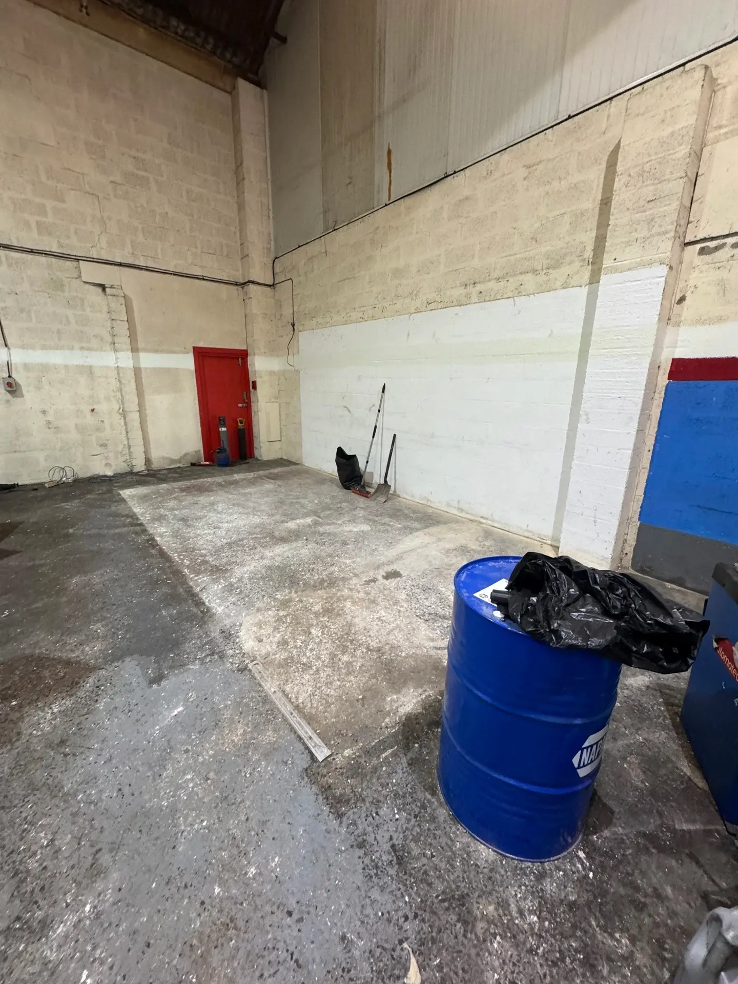 Empty commercial unit floor swept clear after a strip-out